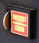 The final black mechanism with 'insert coin' sticker