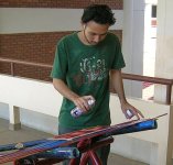 Student spray-painting the cars.