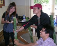 students drilling bamboo poles