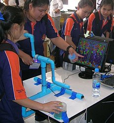 Students playingCoffee Grinder Puzzle Bobble at Payap University