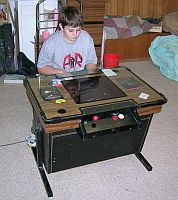 My son playing our Gyruss cocktail machine