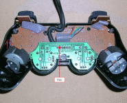 DualShockcontroller with the bottom half of the case removed showing Vcc solderpoint