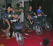 Thai university students playing GL-Tron indoors using three motorbikes