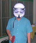 A friend playing ping pong in the Stormtrooper helmet